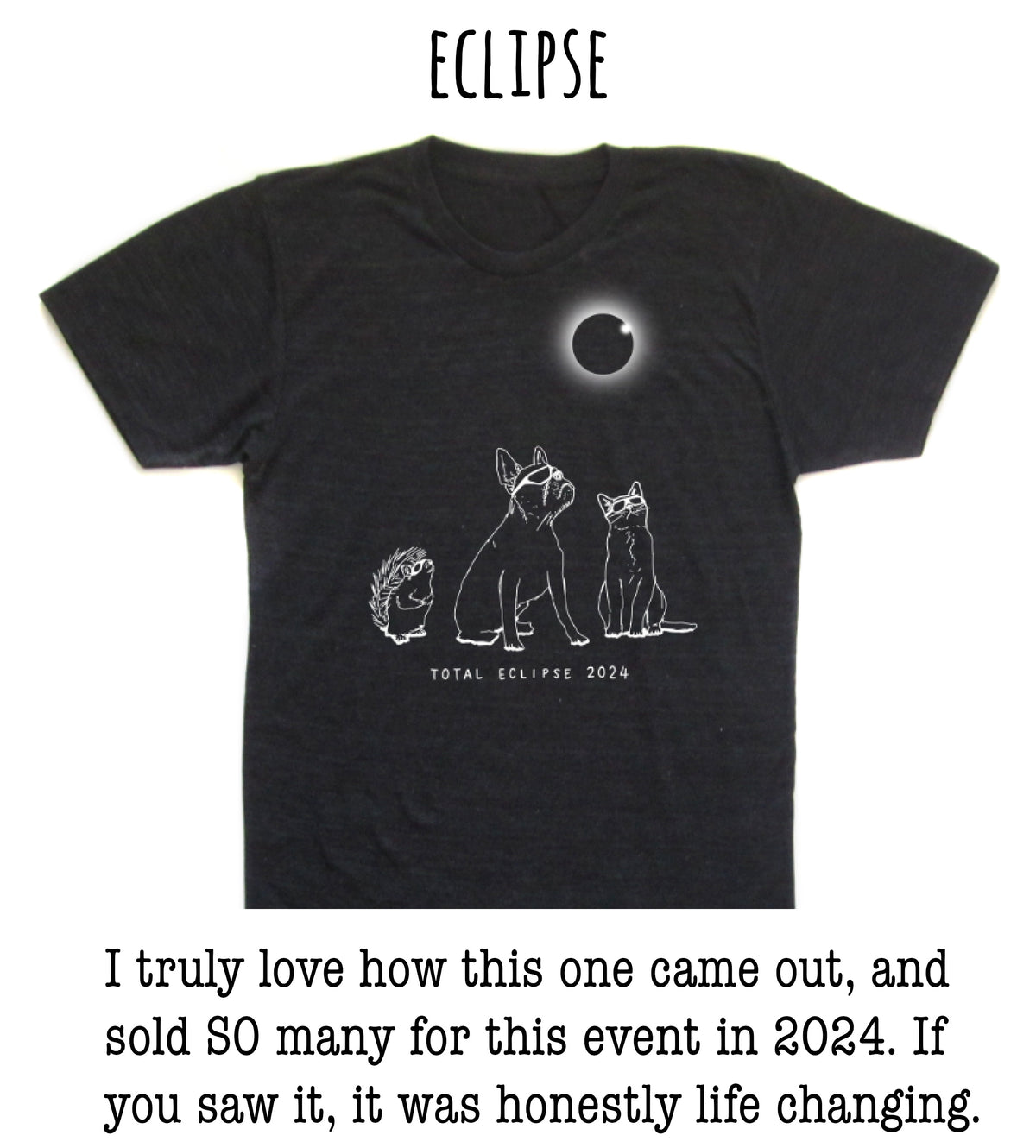 The image is a black t-shirt with a graphic design depicting a total eclipse, featuring a moon and three animals - a dog, a cat, and a hedgehog - against a dark background.