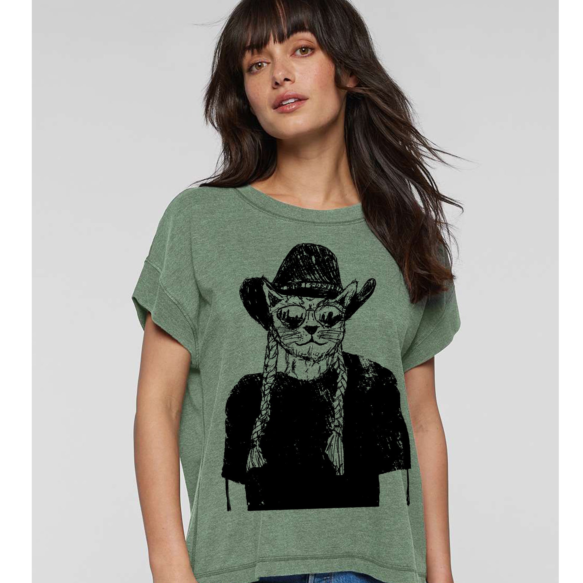 A woman wearing a green t-shirt with a graphic of a cat wearing a cowboy hat and sunglasses.