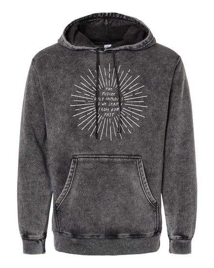 A black hoodie with a white graphic design on the front. The design features a sunburst pattern with the text "The future is only as bright as your past" written around it.