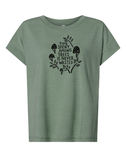 A green t-shirt with a graphic design featuring a mushroom and leaves, along with the text "Time spent among trees is never wasted".