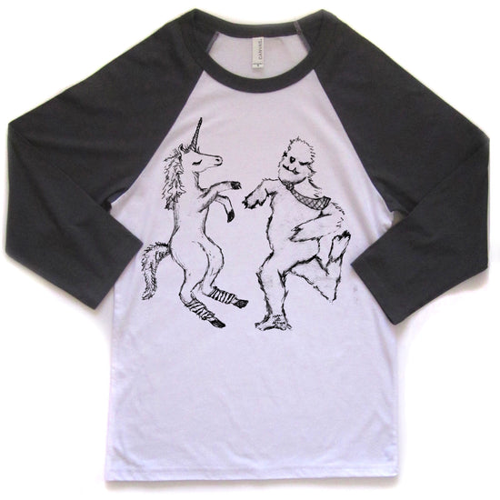 a white and black t-shirt with a graphic design depicting a unicorn and a creature resembling a bear or similar animal.