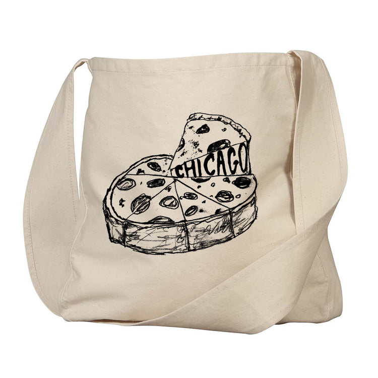 A beige canvas tote bag with a black and white illustration of a slice of pizza with the word "CHICAGO" written on it.