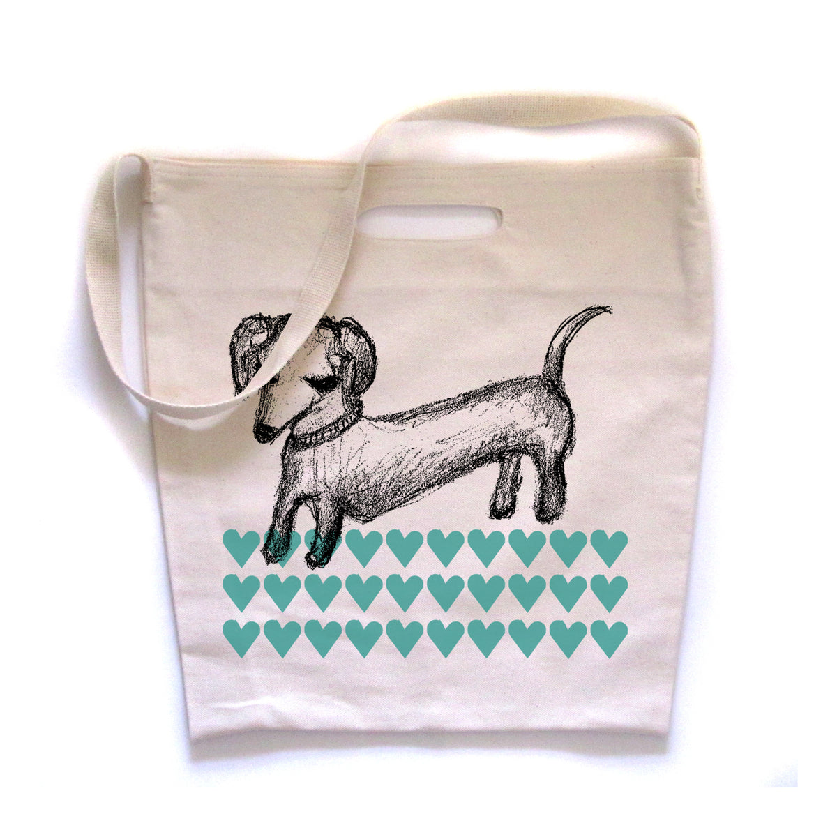 a white tote bag with a black and white illustration of a dachshund dog and a pattern of green hearts on it.