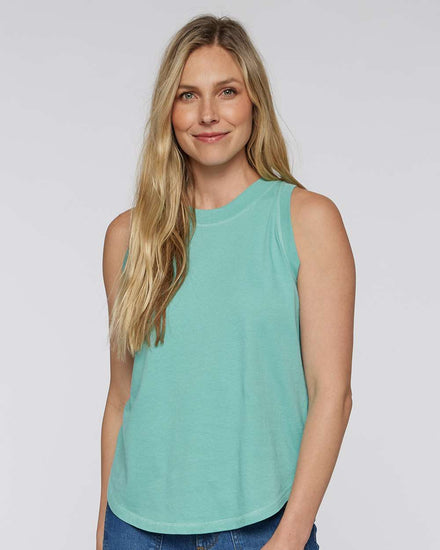 A woman with long blonde hair is smiling and wearing a turquoise sleeveless top.