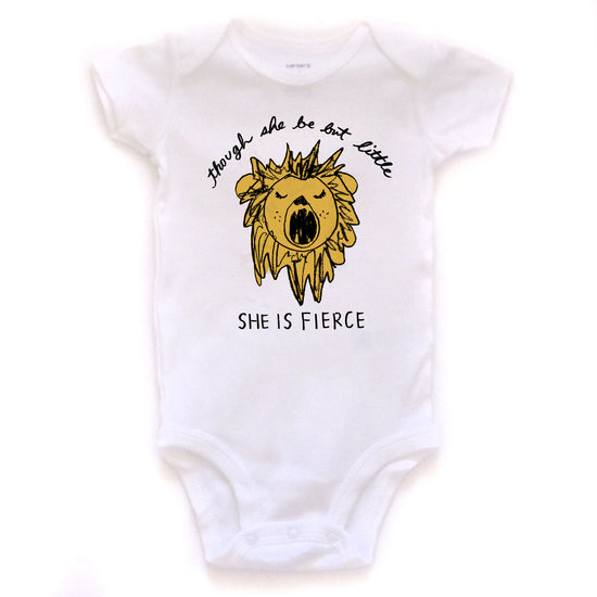 A white baby onesie with a yellow lion graphic and the text "She is fierce" printed on it.