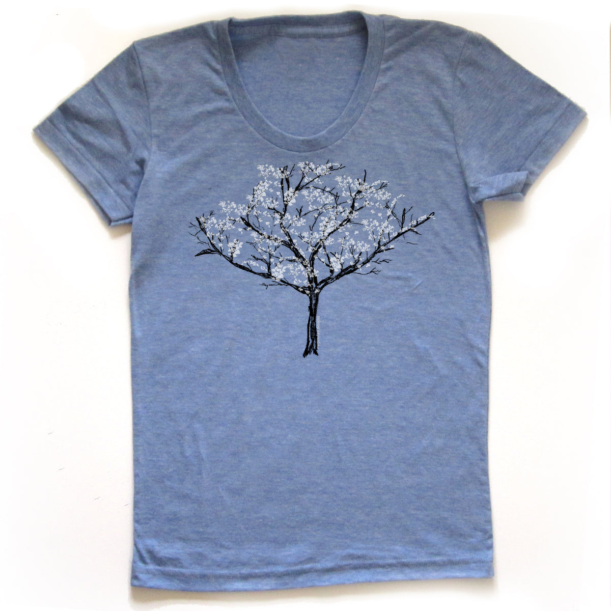 A blue t-shirt with a graphic design of a tree with white flowers printed on it.