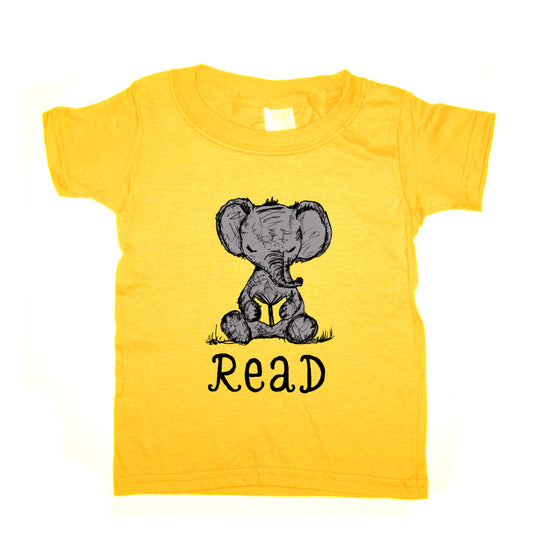 A yellow t-shirt with a cartoon elephant holding a book and the text "Read" below it.