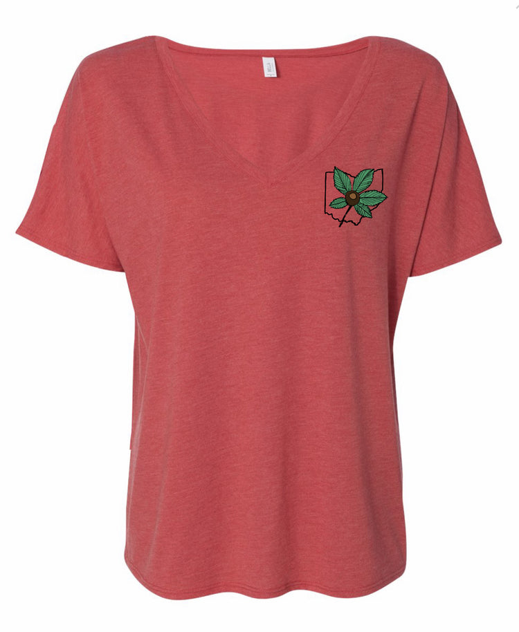 A red t-shirt with a graphic design on the front, featuring a green leaf and a flower-like shape.