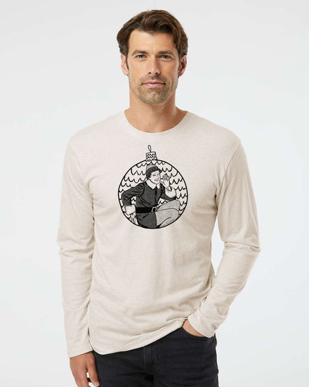 A man wearing a long-sleeved t-shirt with a graphic design of a person in a hat and coat.