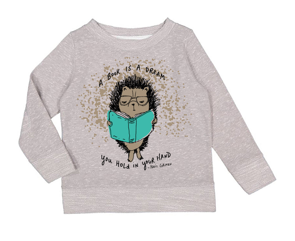 A gray sweatshirt with a cartoon hedgehog holding a book and the text "A book is a dream you hold in your hand" printed on it.