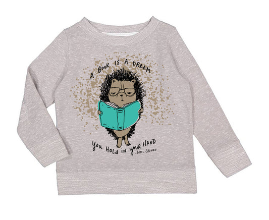 A gray sweatshirt with a cartoon hedgehog holding a book and the text "A book is a dream you hold in your hand" printed on it.