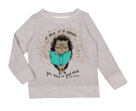A gray sweatshirt with a cartoon hedgehog holding a book and the text "A book is a dream you hold in your hand" printed on it.
