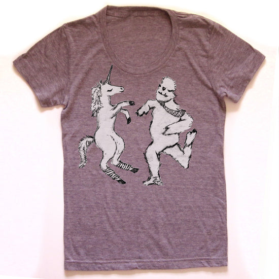 A gray t-shirt with a graphic design depicting a unicorn and a creature resembling a bear or similar animal.