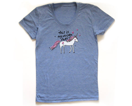 A blue t-shirt with a graphic of a white unicorn and the text "This is my unicorn shirt" printed on it.