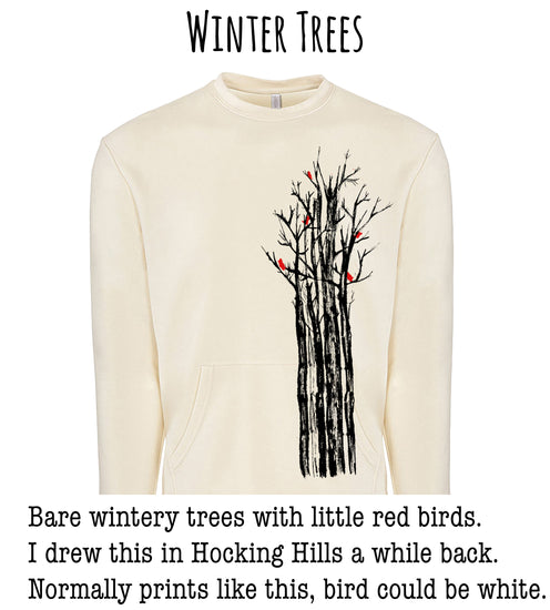 A white sweater with a graphic design depicting a group of bare winter trees with red birds perched on them.