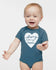 A smiling baby boy wearing a blue onesie with a heart and the text "Strong like my mom" printed on it.