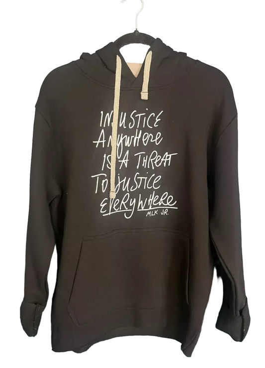 A black hoodie with white text printed on it.