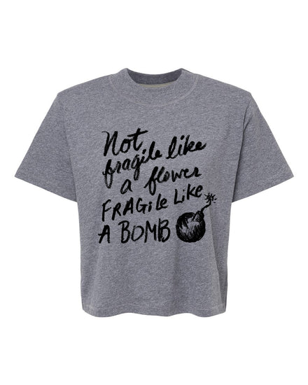 A gray t-shirt with a printed text design that reads "Not, like, fragile like, fragile like a bomb".