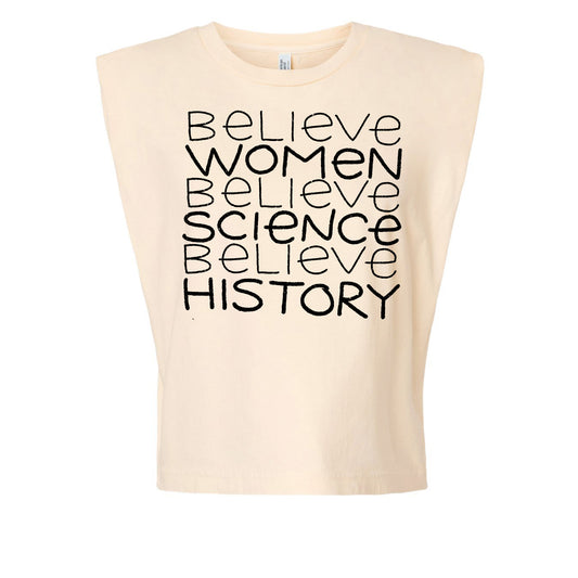 A beige t-shirt with the text "Believe Women Believe Science Believe History" printed on it in a vertical arrangement.