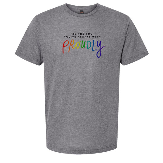 A gray t-shirt with the text "Be the you, you've always been proudly" printed on it.