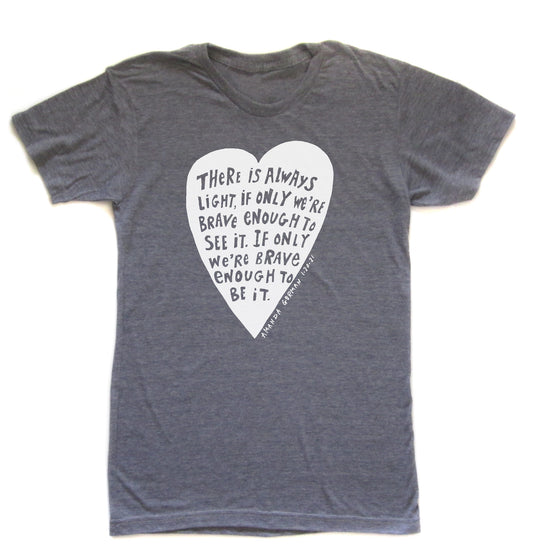 a gray t-shirt with a white heart-shaped graphic containing a quote about bravery and courage.