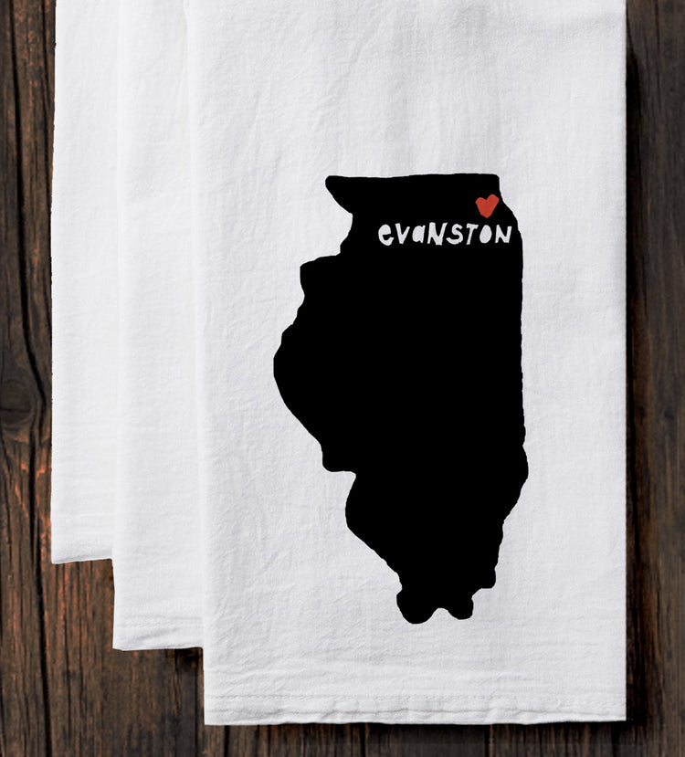 A white towel with a black silhouette of the state of Illinois and the word "Evanston" printed on it.