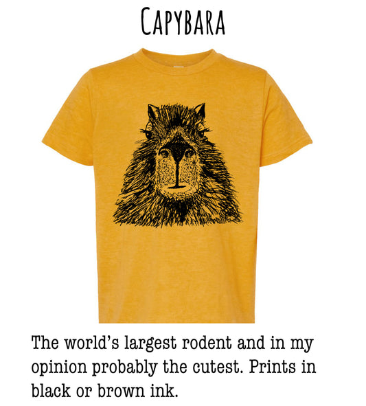 A yellow t-shirt with a black illustration of a rodent's face, accompanied by text stating that the world's largest rodent and in the wearer's opinion, probably the cutest. The text also mentions that the prints are in black or brown ink.