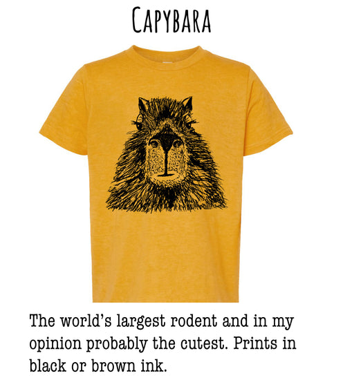 A yellow t-shirt with a black illustration of a rodent's face, accompanied by text stating that the world's largest rodent and in the wearer's opinion, probably the cutest. The text also mentions that the prints are in black or brown ink.