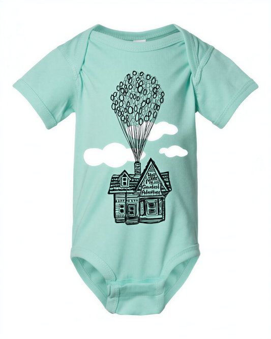 A light blue baby onesie with a graphic design depicting a house with balloons floating above it.