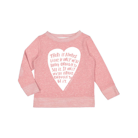 A pink long-sleeved shirt with a white heart-shaped graphic and text printed on it.