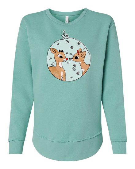 A turquoise sweatshirt with a graphic design featuring two cartoon reindeer inside a snow globe.