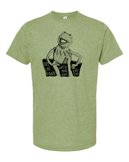 A green t-shirt with a black and white graphic of Kermit the Frog sitting on a couch and the text "Life like a movie" printed on it.