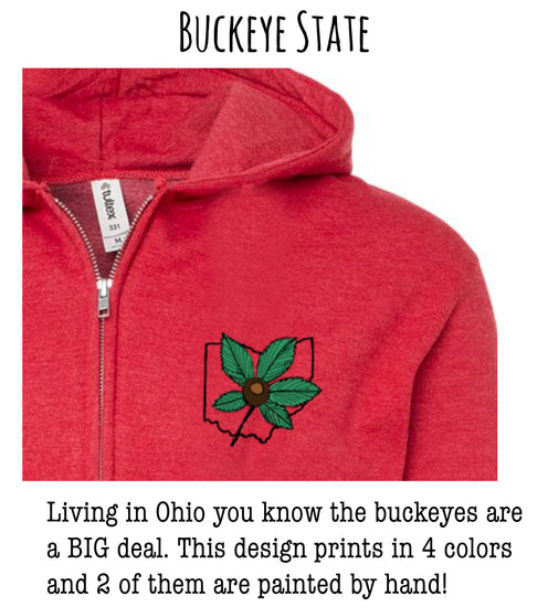A red hoodie with a graphic of the Ohio state flower, which is a Buckeye, printed on the front.