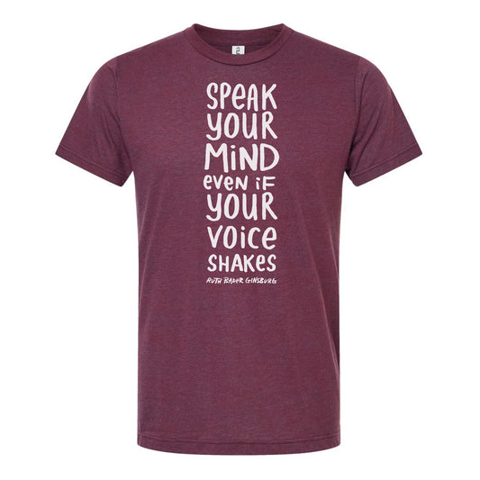 The image is a maroon t-shirt with white text printed on it. The text reads "Speak your mind even if your voice shakes".
