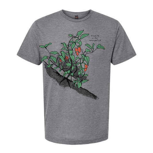 A gray t-shirt with a graphic design depicting a plant with green leaves and orange flowers.