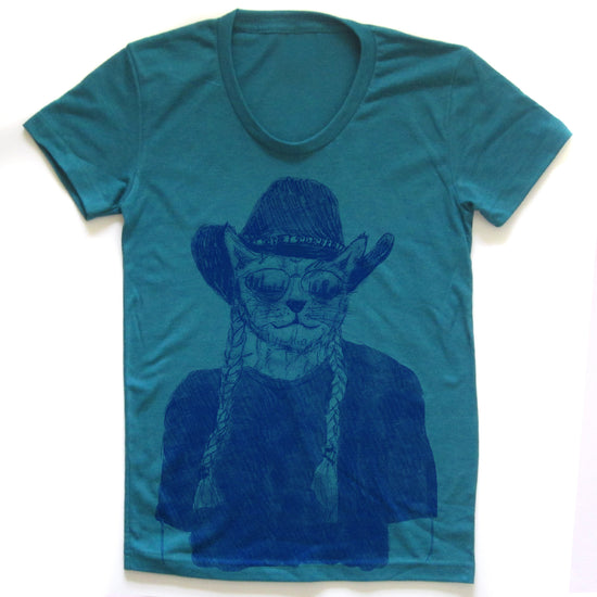 A teal-colored t-shirt with a graphic design depicting a cat wearing a cowboy hat and sunglasses.
