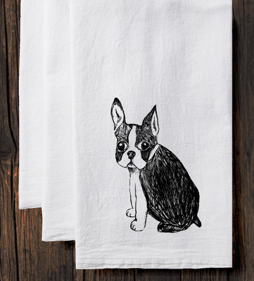 A black and white illustration of a dog is depicted on a white towel.