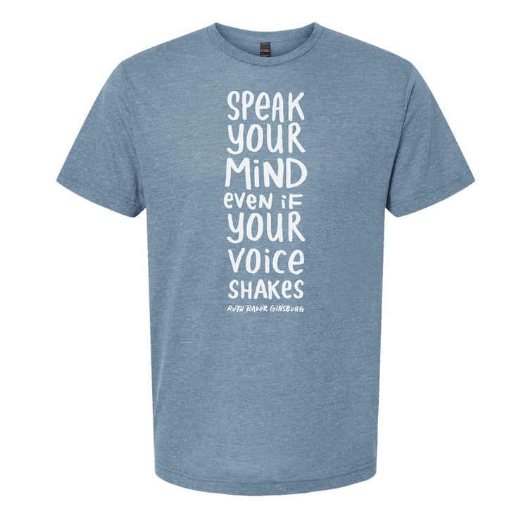A light blue t-shirt with white text printed on it. The text reads "Speak your mind even if your voice shakes".