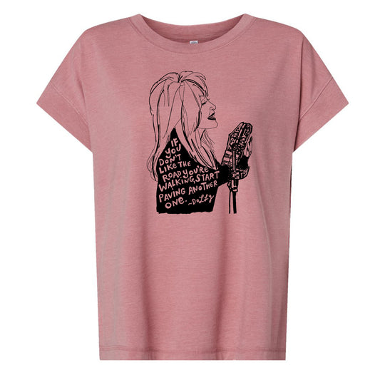 A pink t-shirt with a black and white graphic design depicting a woman's profile with text overlaid.