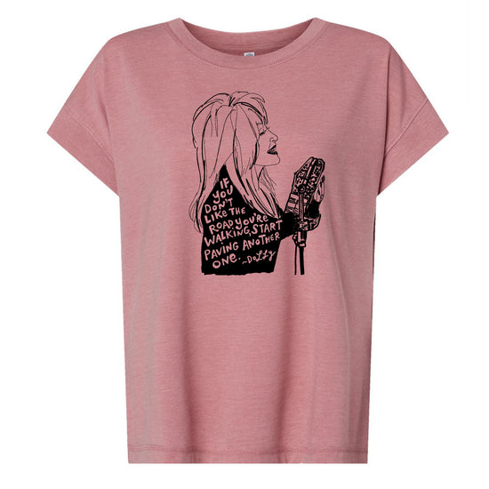 A pink t-shirt with a black and white graphic design depicting a woman's profile with text overlaid.