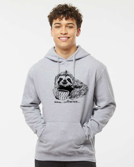 A young man wearing a grey hoodie with a graphic of a sloth and the text "mmm...coffee."