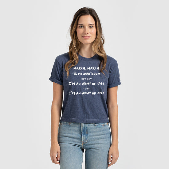 A woman wearing a blue t-shirt with white text printed on it.