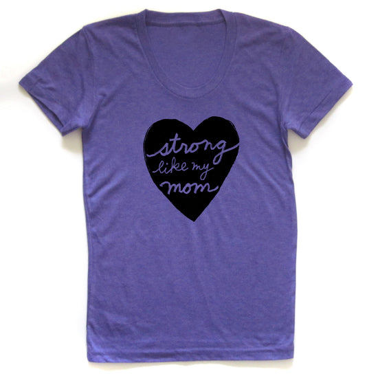 A purple t-shirt with a heart-shaped graphic and the text "Strong like my mom" printed on it.