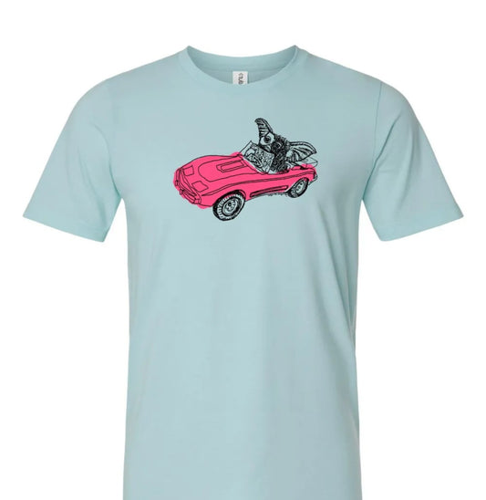 A light blue t-shirt with a graphic design depicting a pink convertible car with a bird perched on the top.