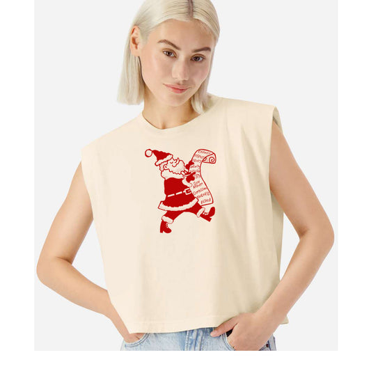 A woman wearing a beige sleeveless top with a red graphic of Santa Claus on it.