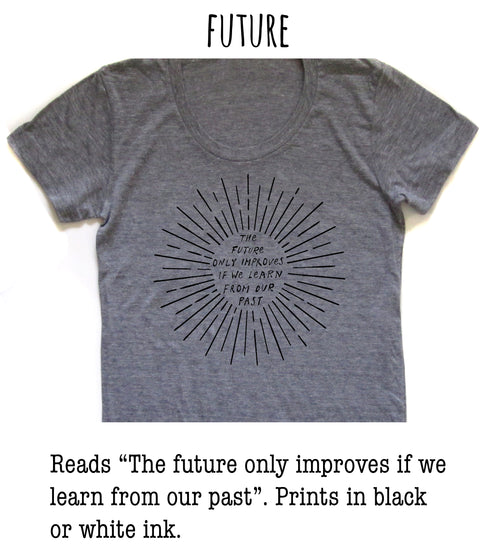 a gray t-shirt with a black graphic design on it. The design consists of a sunburst pattern with the text "The future only improves if we learn from our past" printed on it.