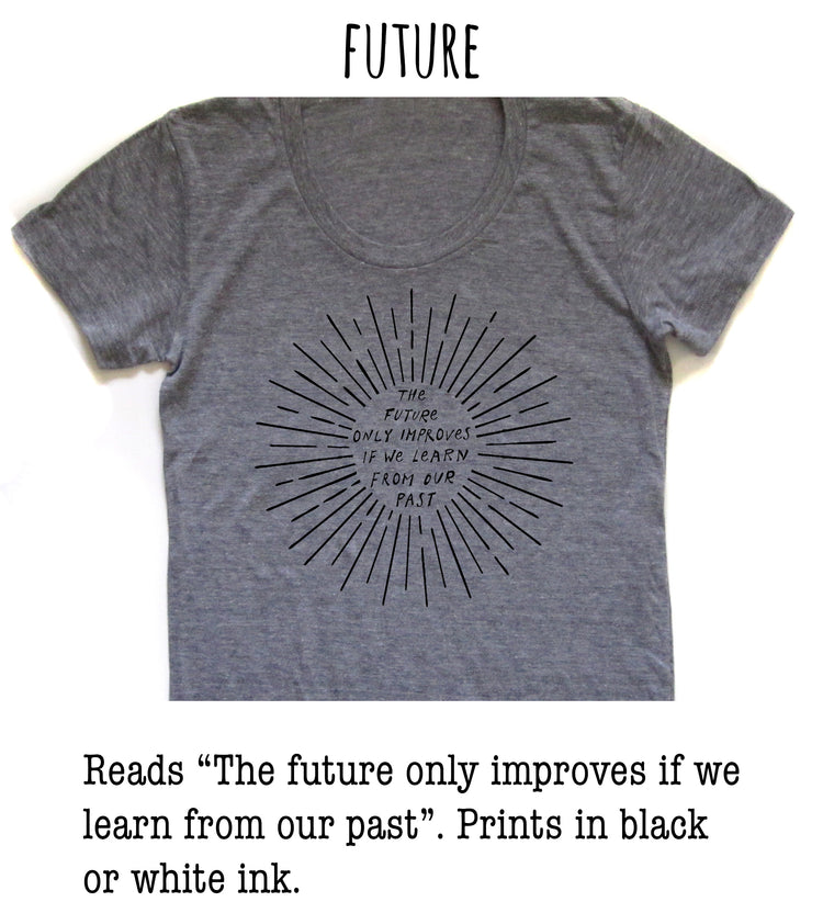 a gray t-shirt with a black graphic design on it. The design consists of a sunburst pattern with the text "The future only improves if we learn from our past" printed on it.