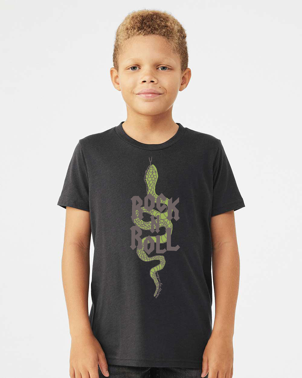 A young boy wearing a black t-shirt with a graphic design of a green snake and the text "Rock on Roll" printed on it.