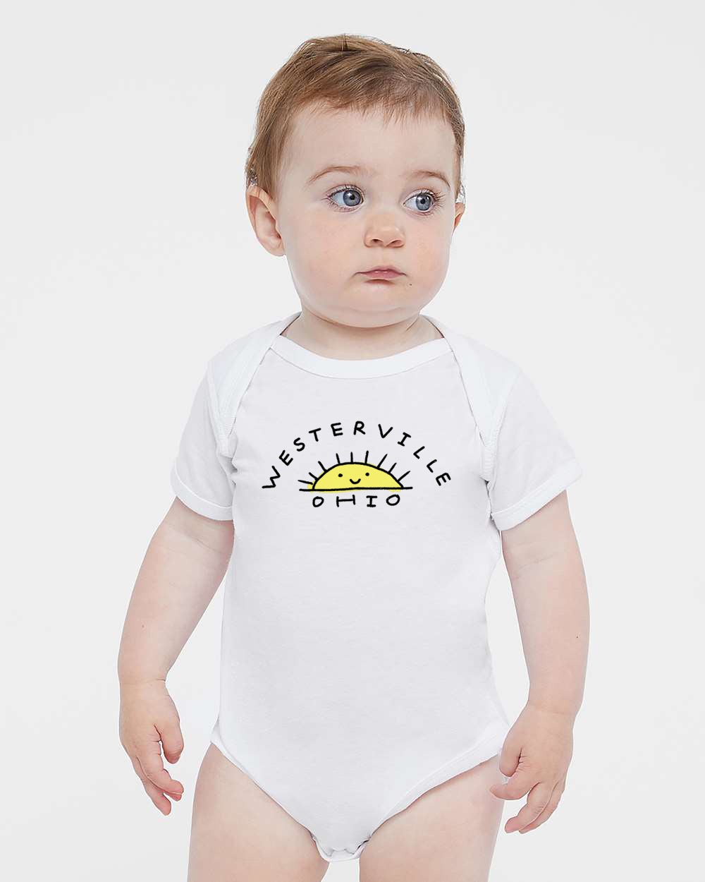 A baby wearing a white onesie with the text "WESTERVILLE OHIO" printed on it.