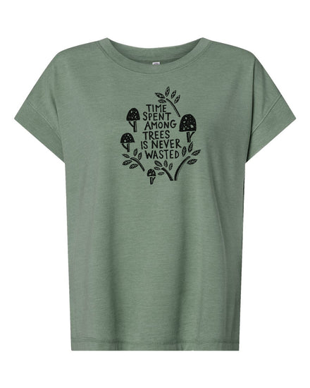 A green t-shirt with a graphic design featuring a mushroom and leaves, along with the text "Time spent among trees is never wasted".